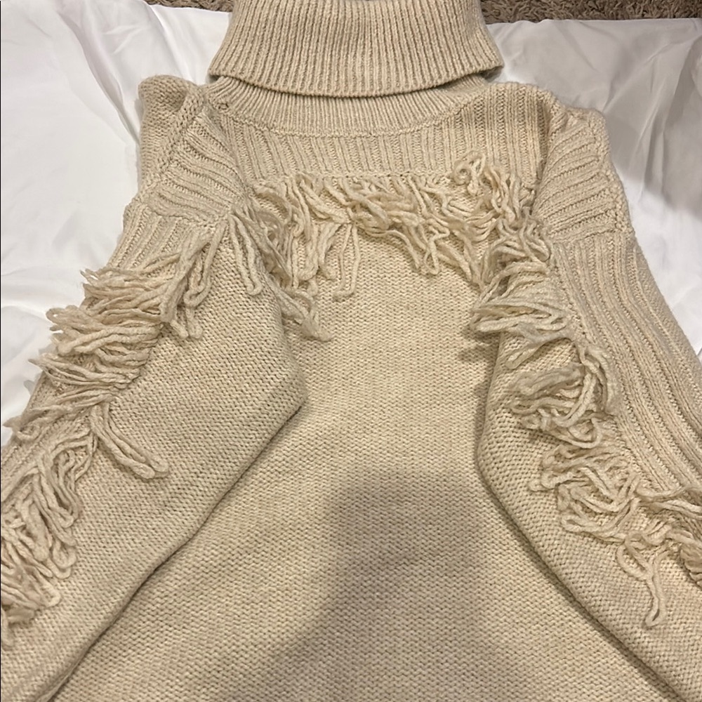 Cozy Beige Turtleneck Sweater with Fringe